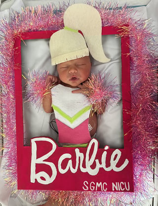 NICU baby dressed as Barbie